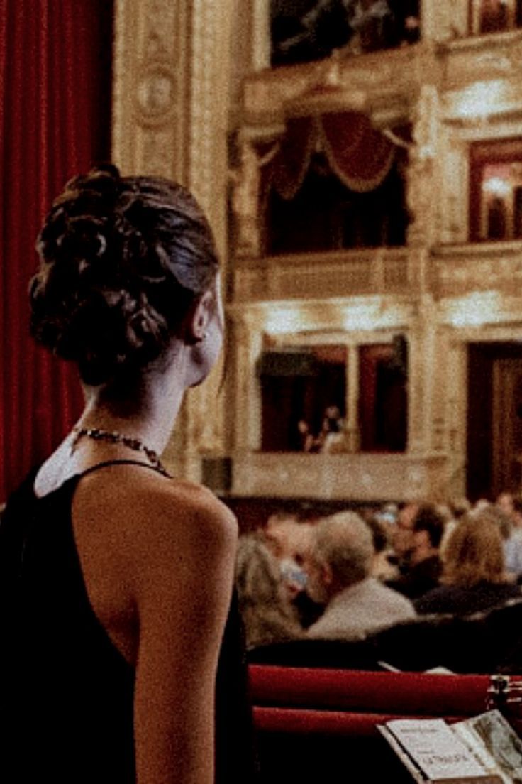 a woman standing in front of a stage