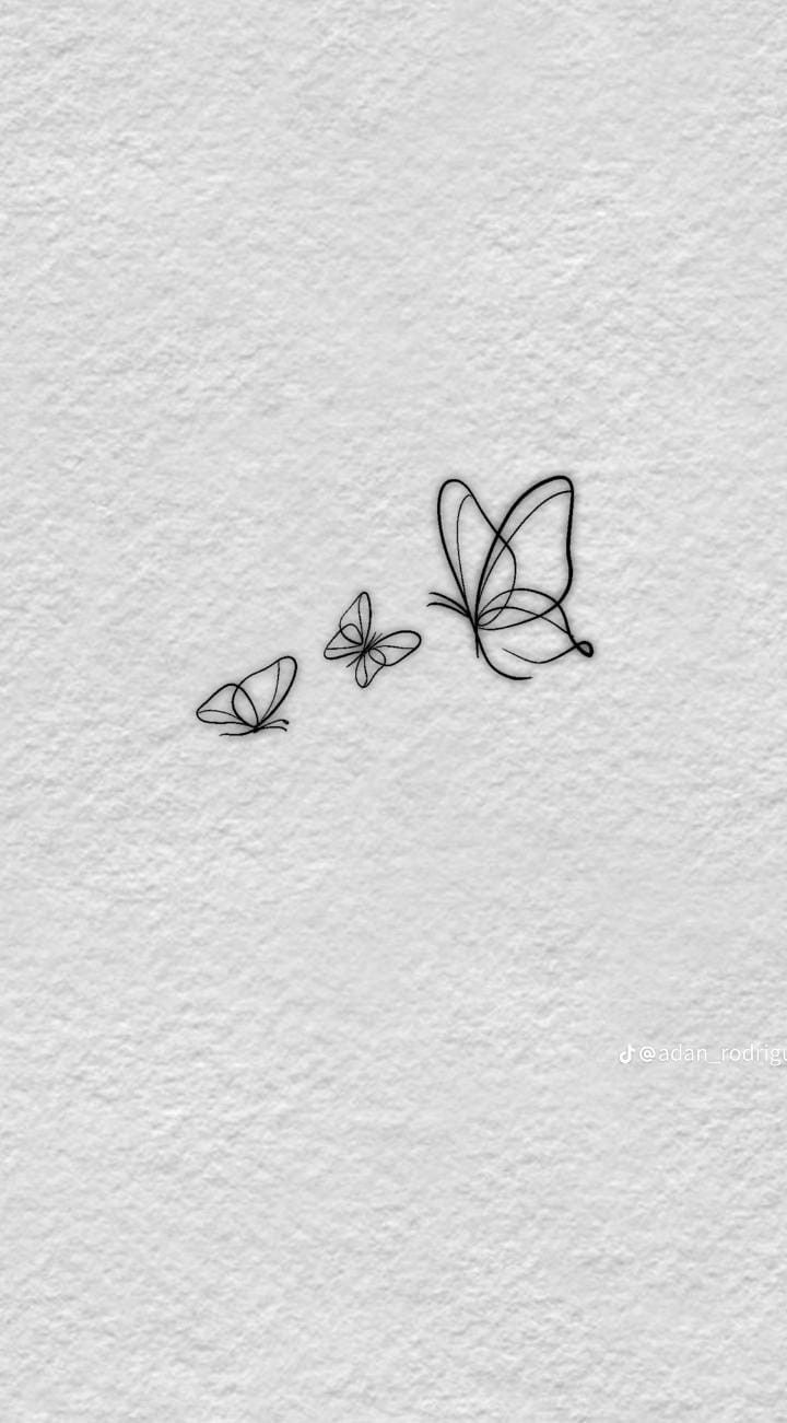 two butterflies flying over each other on a white paper background with the words love written in black ink