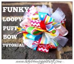 a close up of a colorful bow on a brick wall with words above it that read funky loopy puff bow