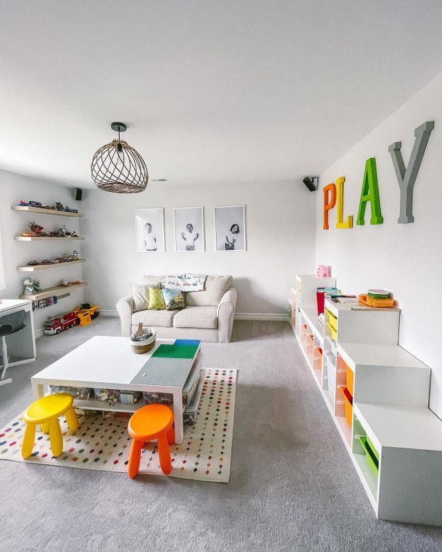 a child's playroom with white furniture and colorful accessories