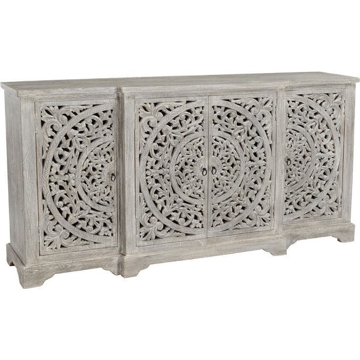 an ornate carved sideboard with four doors and three drawers, in whitewashed wood