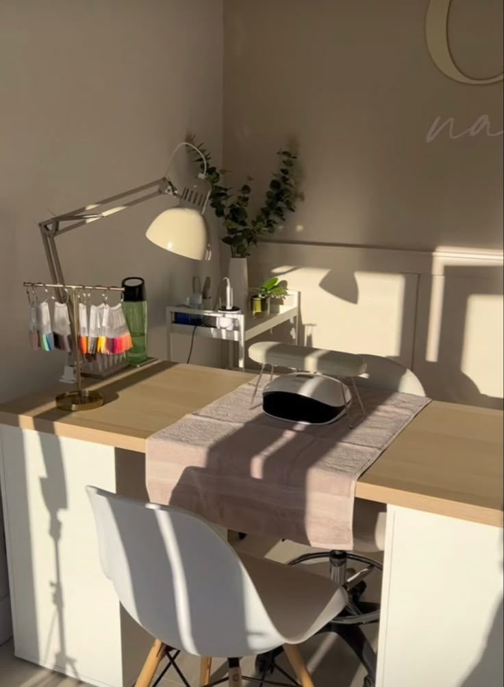 a desk with two chairs and a laptop on it