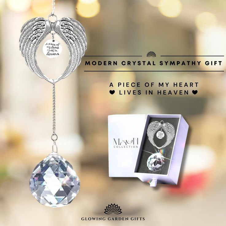 the modern crystal sympathy gift is in its box and it has an angel charm hanging from it