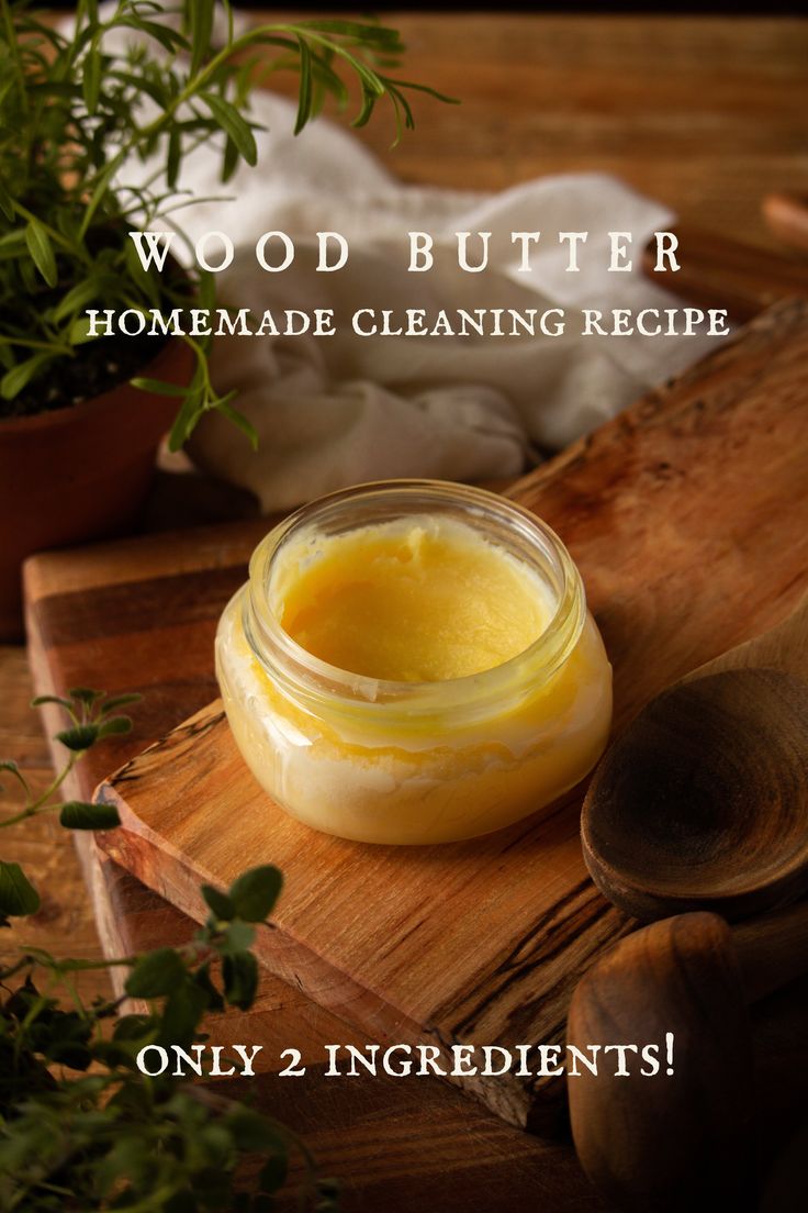 a jar of wood butter sitting on top of a wooden cutting board