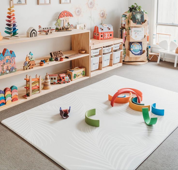 a child's play room with toys on the floor and shelves in the background