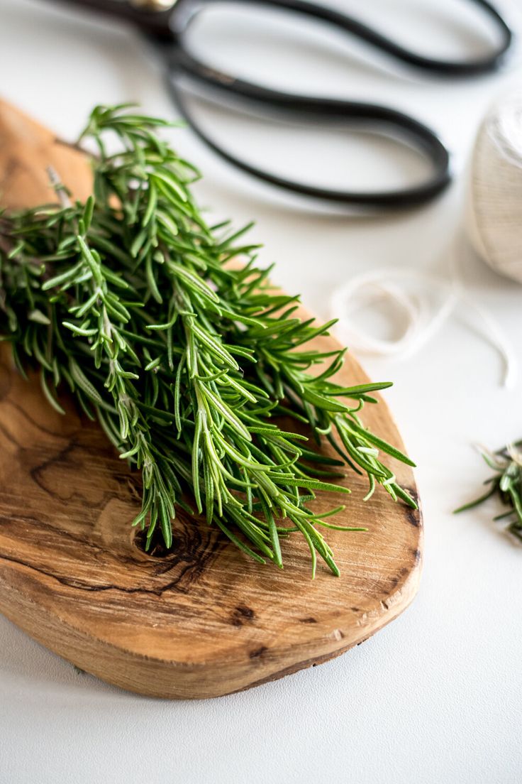 a bunch of fresh herbs on a cutting board