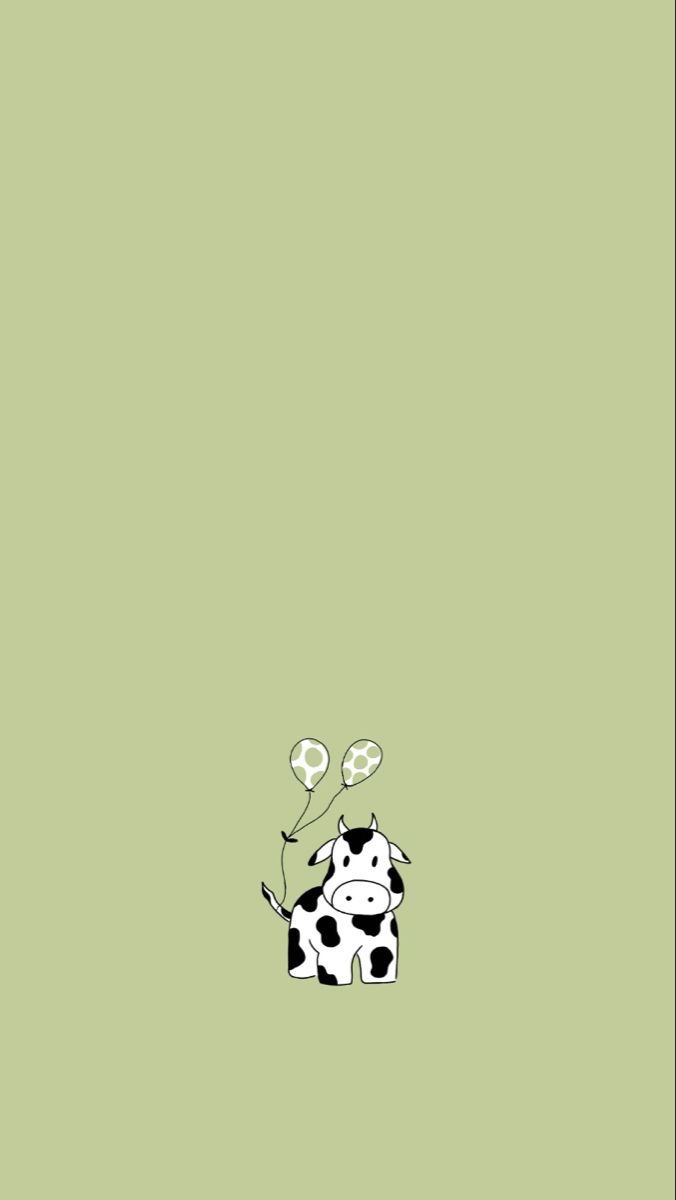 a black and white cow sitting on top of a green floor next to a light green wall