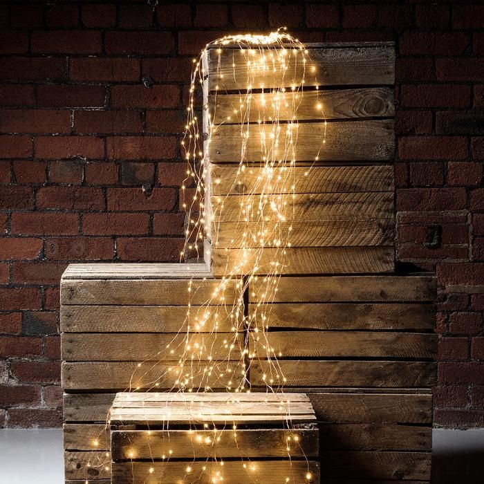 three wooden boxes with lights on them sitting in front of a brick wall and floor