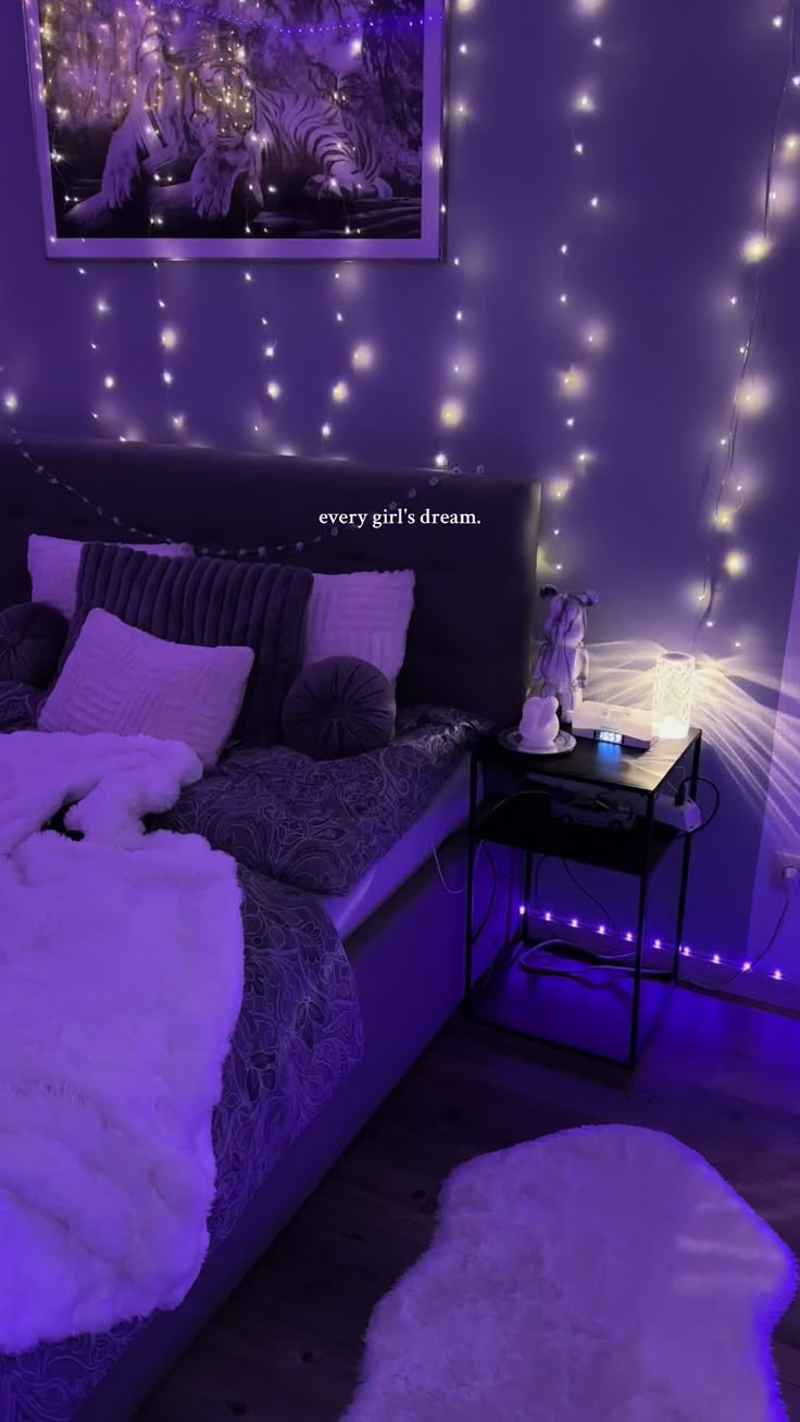 a bedroom with purple lighting and white fur rugs on the bed in front of it