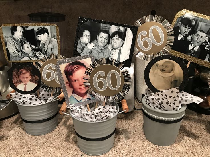 a table topped with buckets filled with cake and pictures