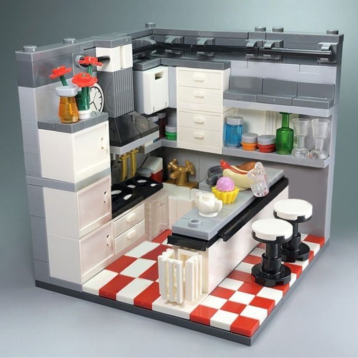 a lego model of a kitchen with red and white checkered flooring