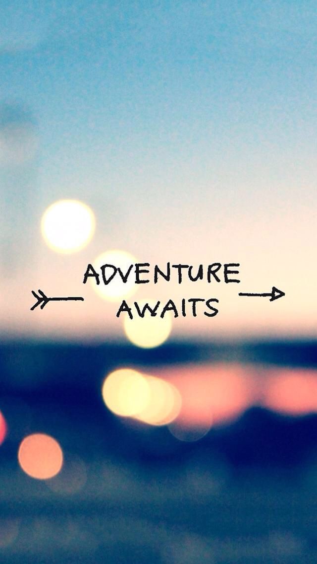 the words adventure await are written on a blurry background