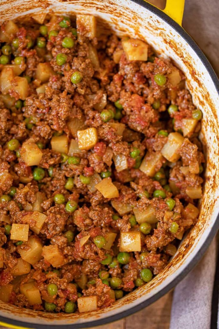 a pot filled with food sitting on top of a wooden table