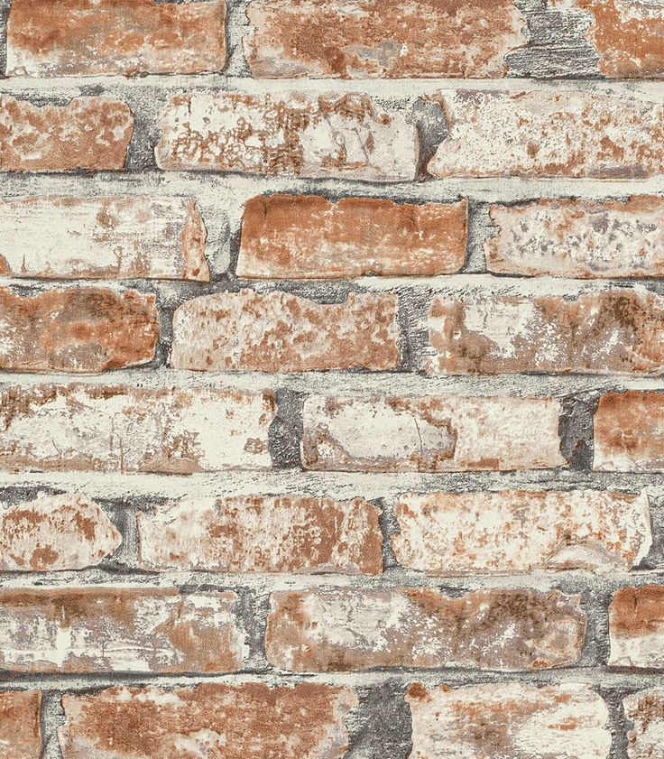 an old brick wall that has been painted brown and white with some rust on it