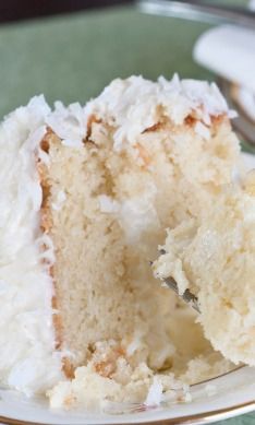 a close up of a piece of cake on a plate with a fork in it