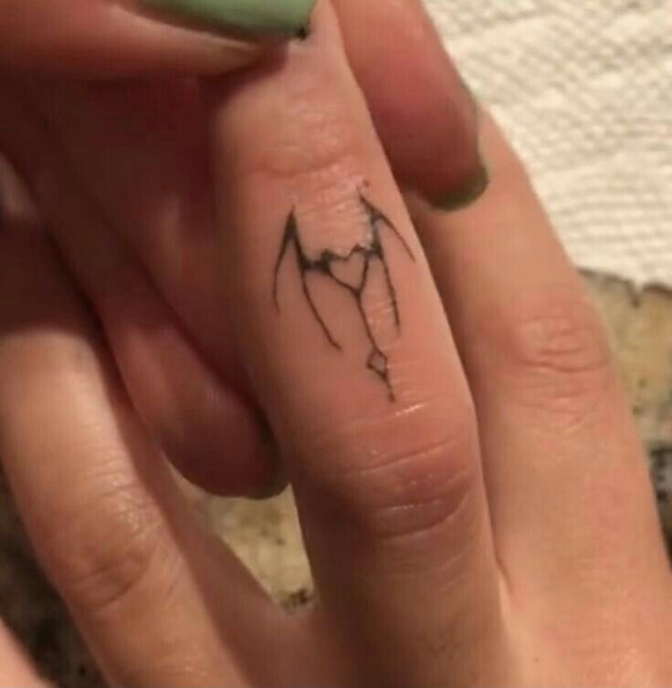 a person with a small tattoo on their finger