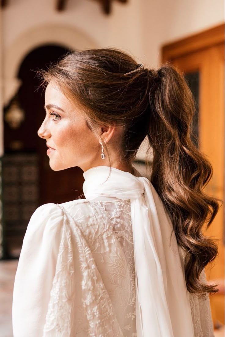 a woman with long hair wearing a white blouse