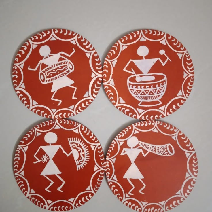 four red stickers with white designs on them