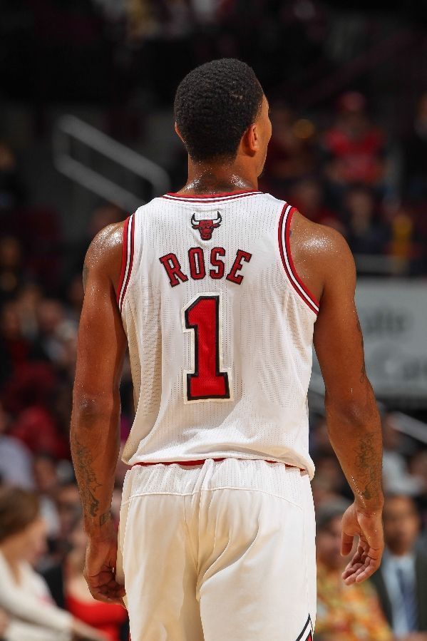 a basketball player with the number 1 on his jersey is standing in front of an audience