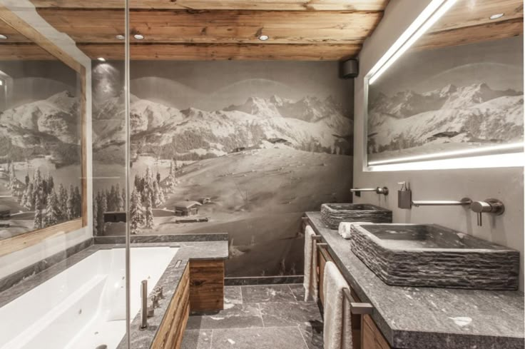 a bathroom with two sinks and a large mural on the wall above it's bathtub