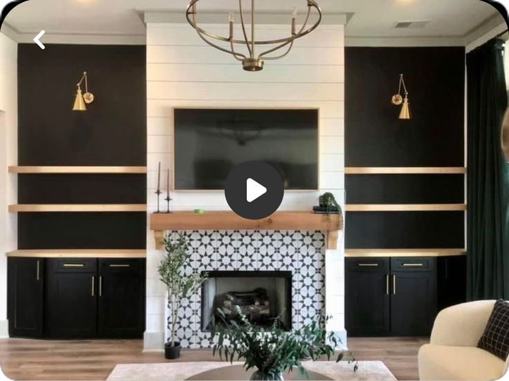 the living room is decorated in black and white with wood trimming on the fireplace