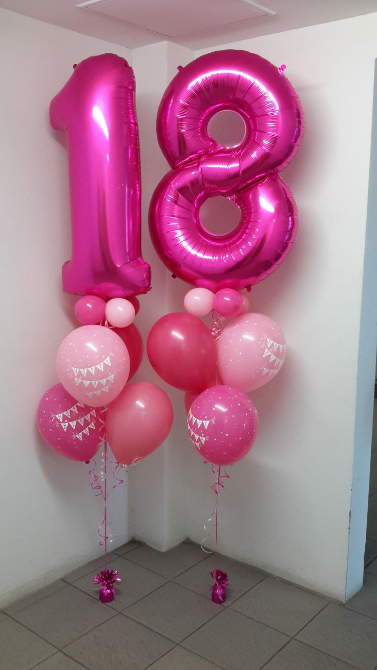 pink balloons are in the shape of the number eight and one balloon is attached to the wall