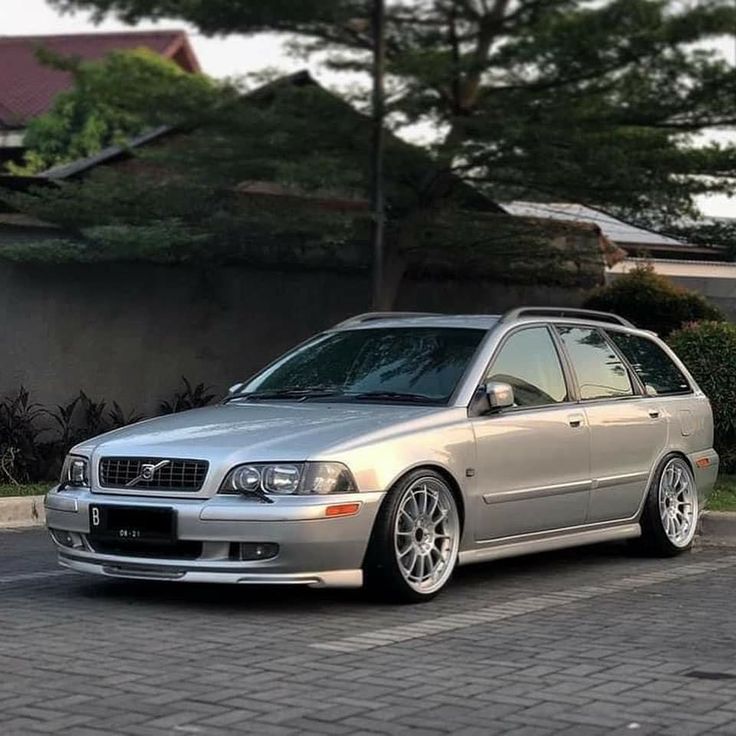 a silver car parked in front of a house