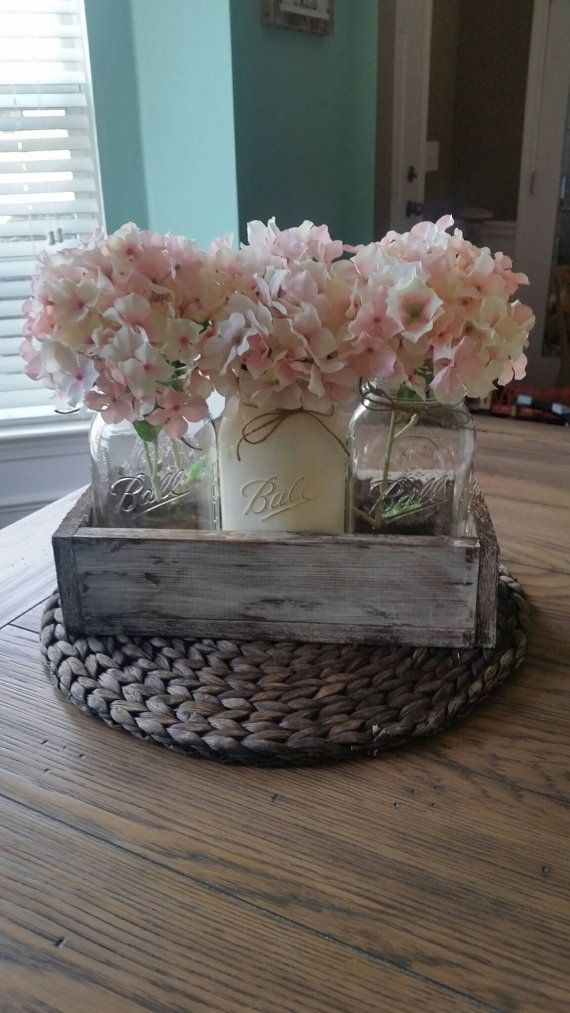 flowers in mason jars are sitting on a tray that is made from an old window sill