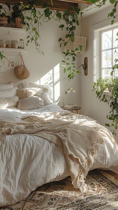 an unmade bed in a bedroom with plants on the wall and windows above it