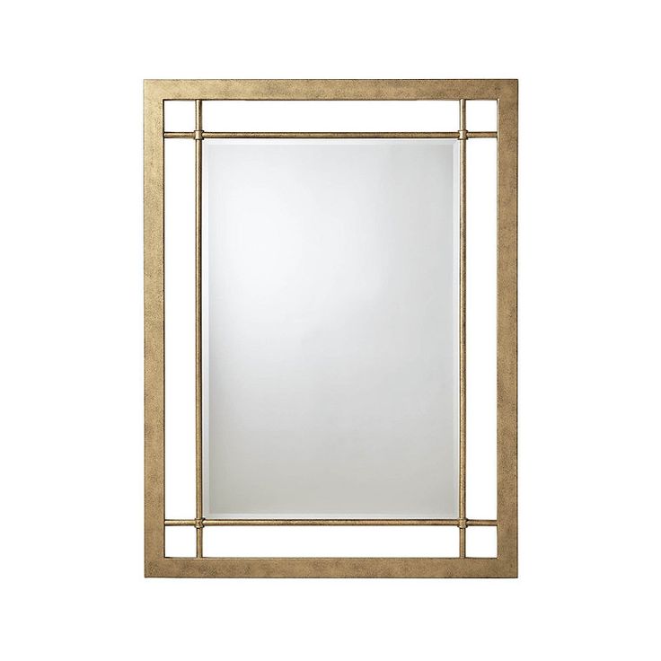 a gold framed mirror on a white wall