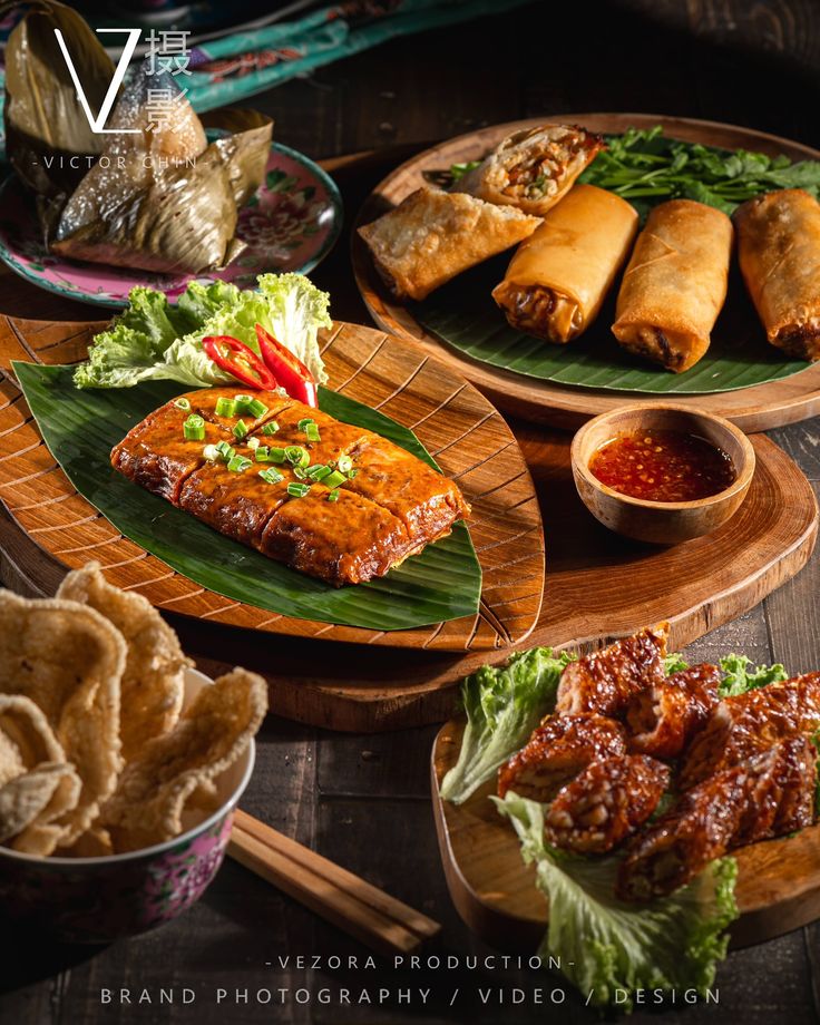 an assortment of food items displayed on wooden platters with dipping sauces and tortillas