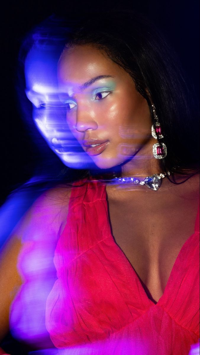 a woman in a red dress posing for the camera