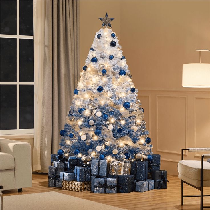 a blue and white christmas tree with presents under it