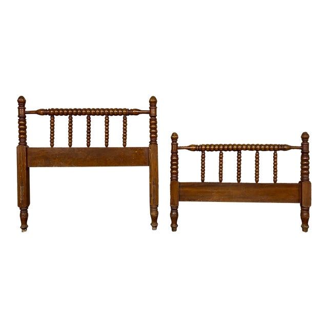 two wooden beds sitting next to each other on top of a white background with no one in it