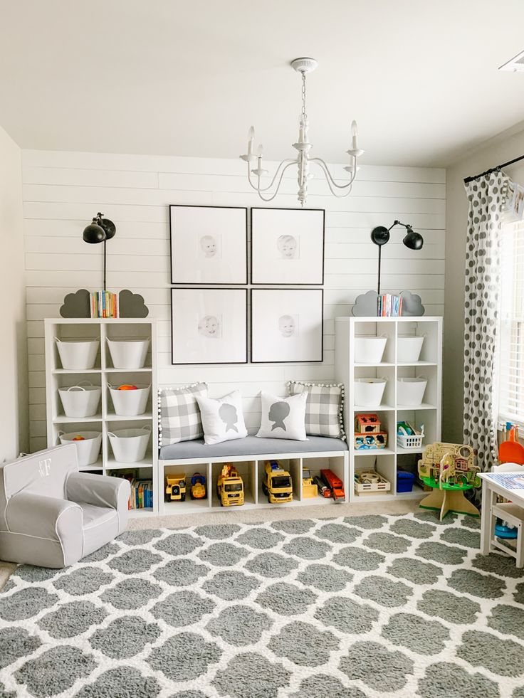 a child's playroom with toys, bookshelves and pictures on the wall