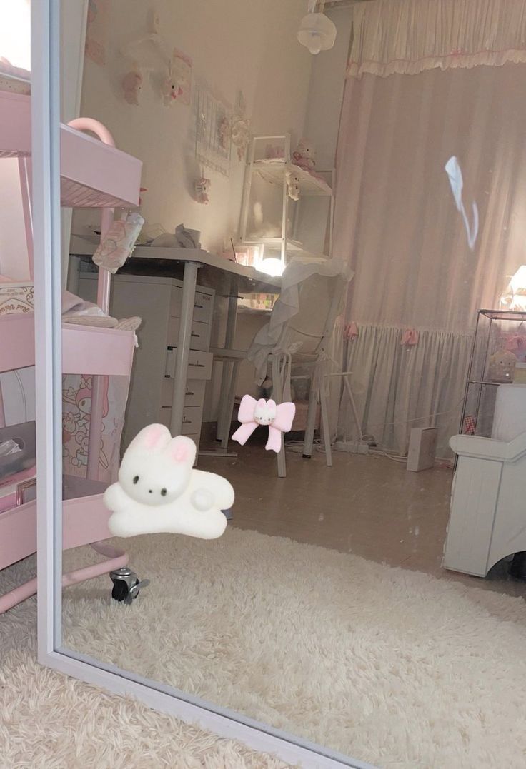 there is a mirror in the room that has a hello kitty decoration on it,