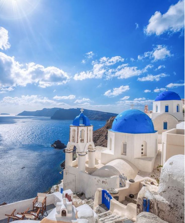 blue and white buildings overlooking the ocean on a sunny day