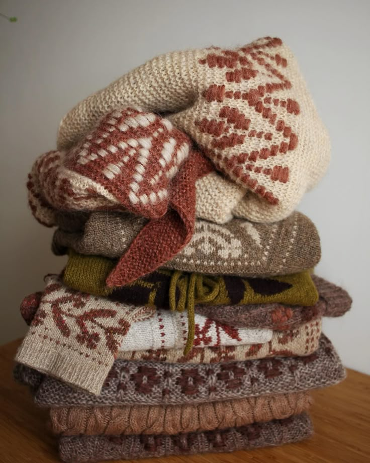 a stack of knitted sweaters on top of each other