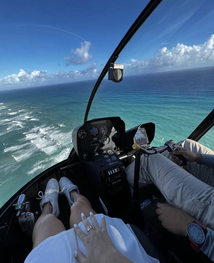 two people are flying in an airplane over the ocean