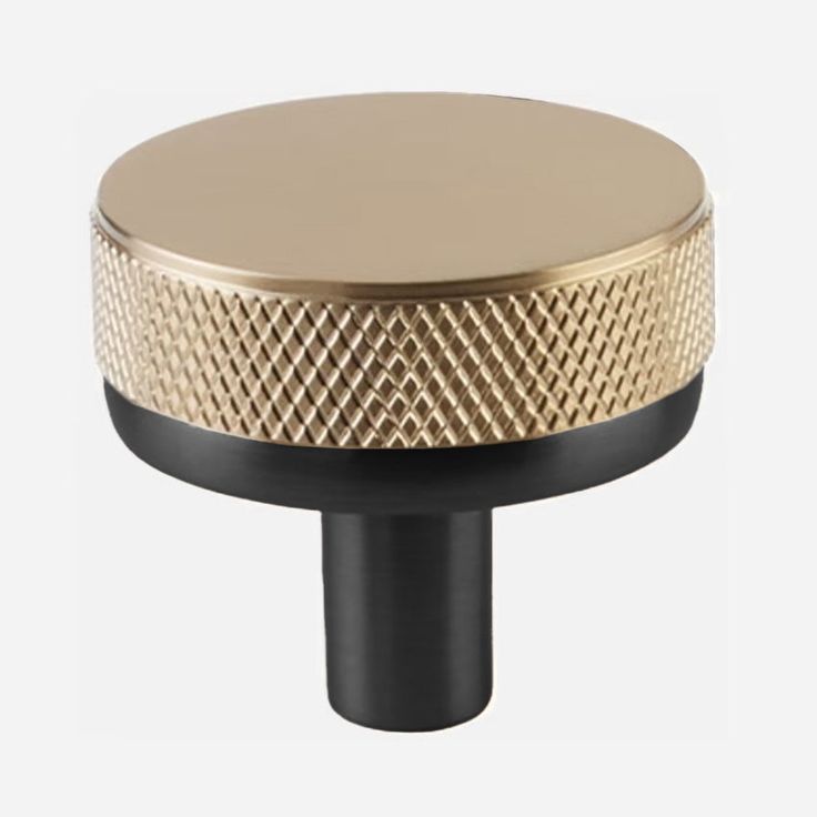 a gold and black knob on a white background