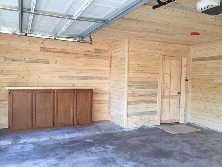 an empty garage with wooden walls and doors