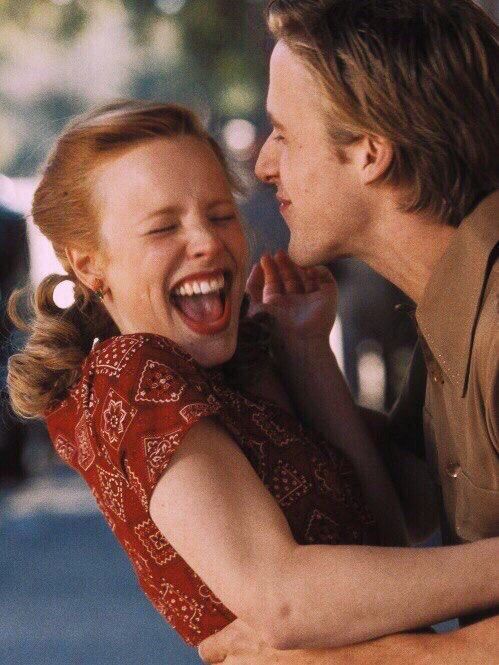 a man and woman laughing together on the street