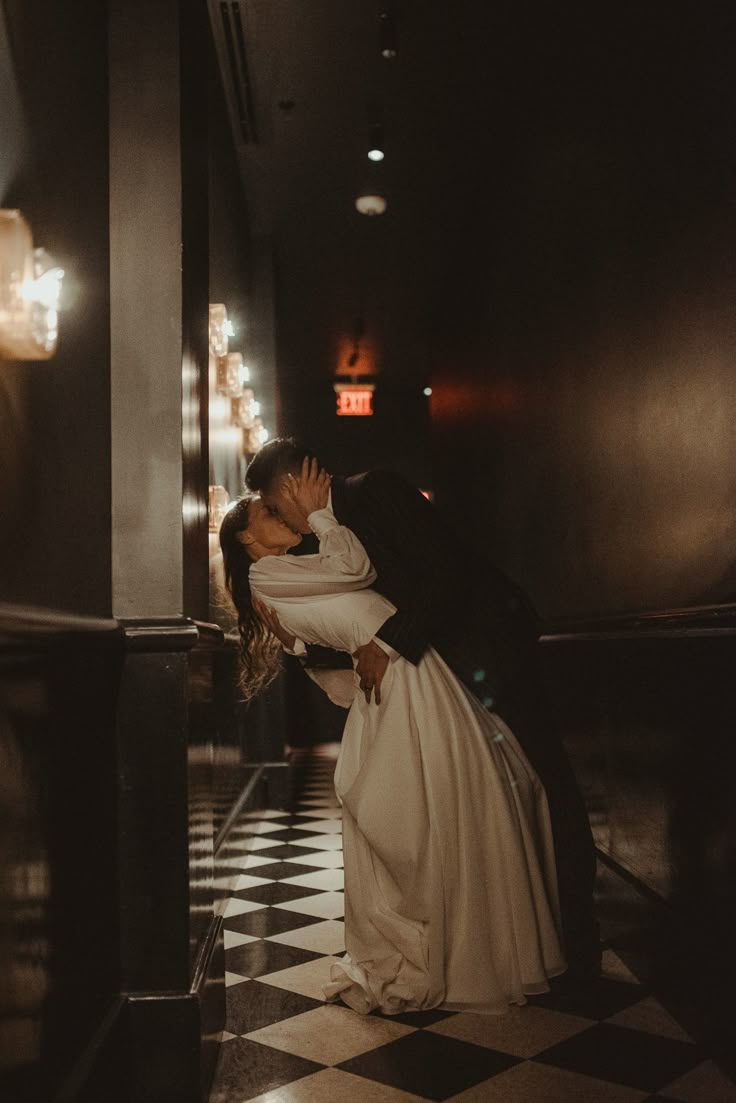 a bride and groom kissing in an elevator