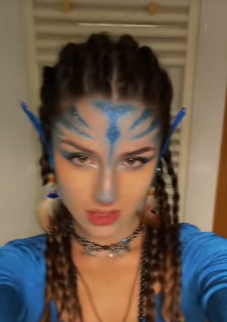 a woman with blue face paint and braids