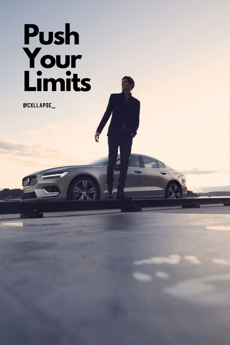 a man standing next to a silver car with the words push your limits on it