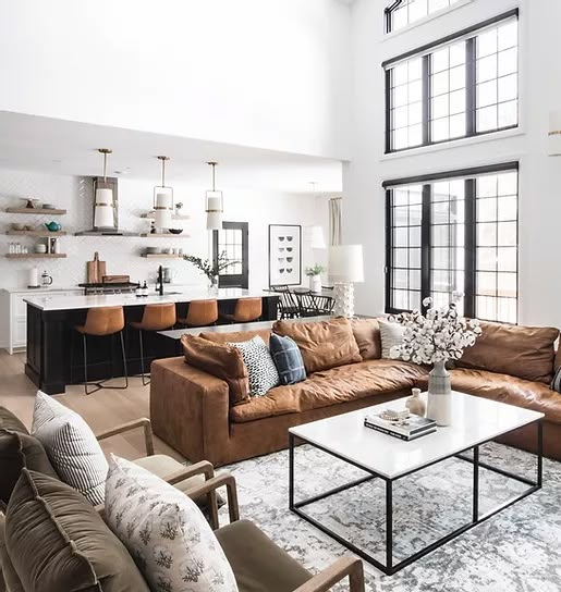 a living room filled with furniture and lots of windows