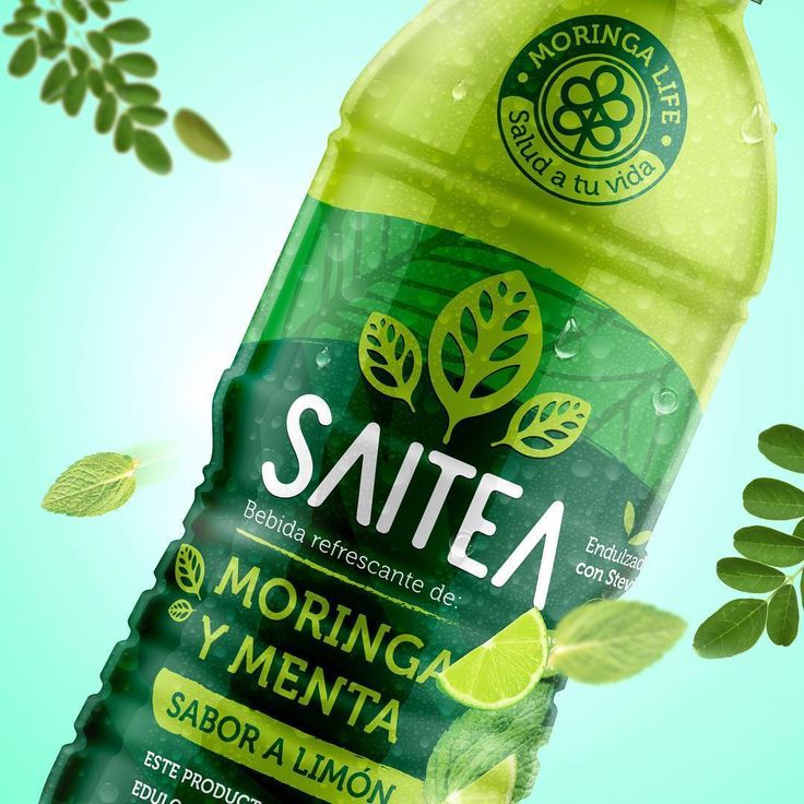 a bottle of sautea on a green background with leaves and flowers around it