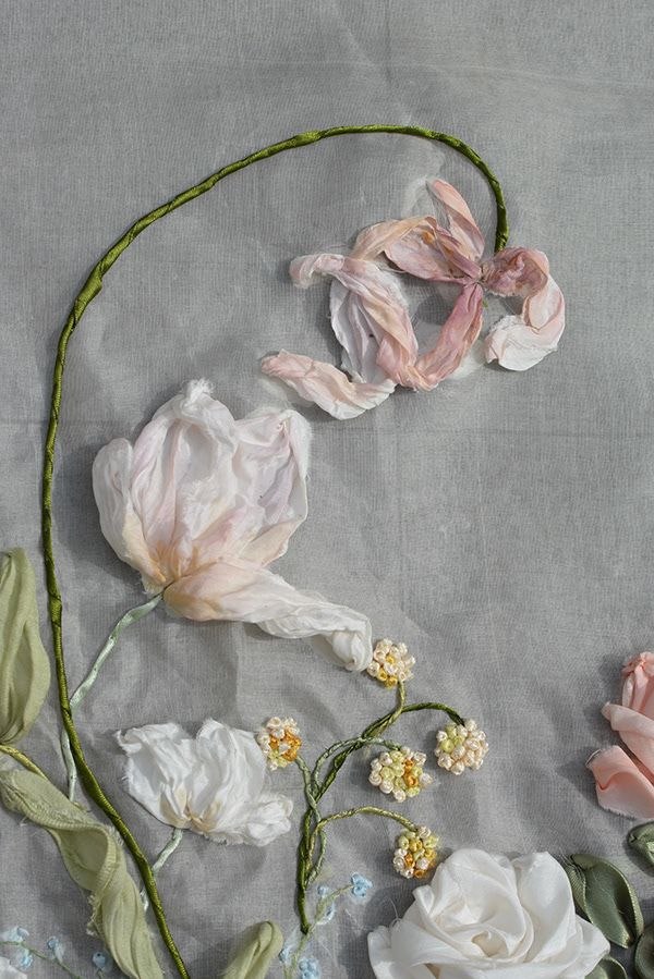 an arrangement of flowers on a table cloth