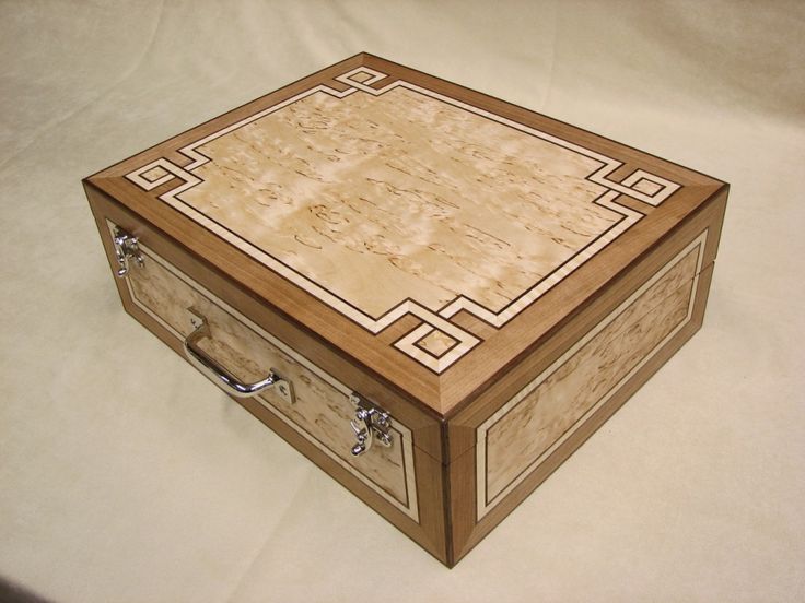 a wooden box sitting on top of a white sheet