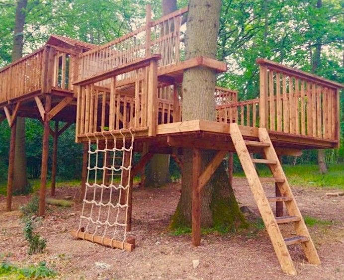 a wooden tree house in the woods